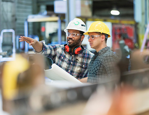 Two construction workers discussing project