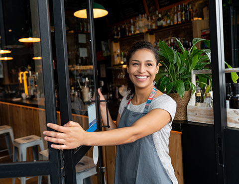 Female business owner opening store