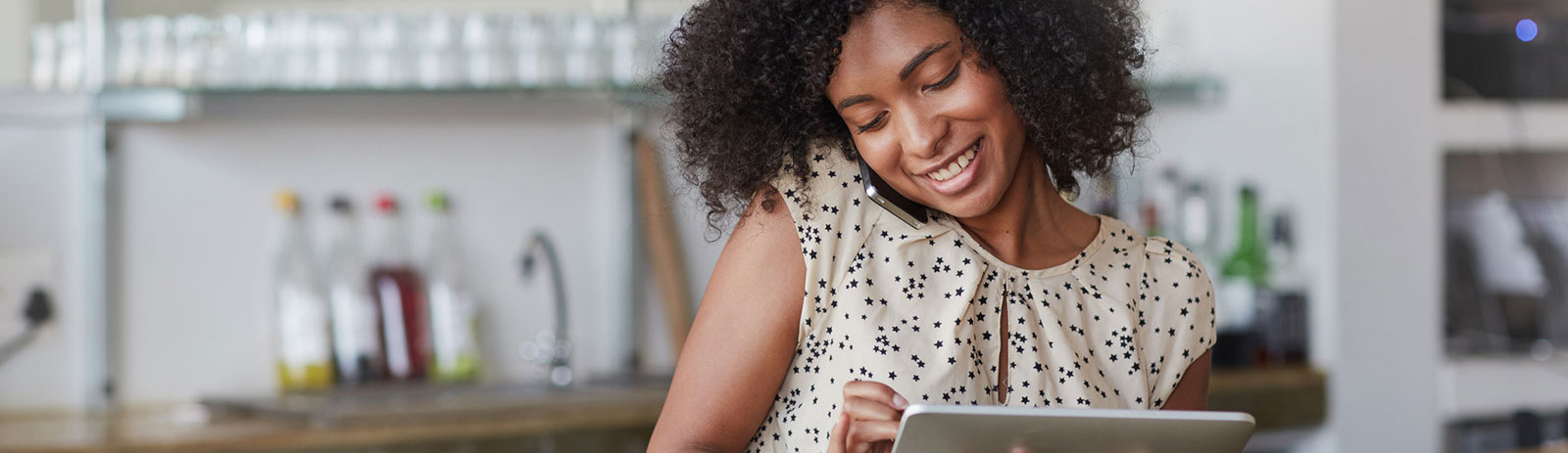 Female business owner working on tablet in store