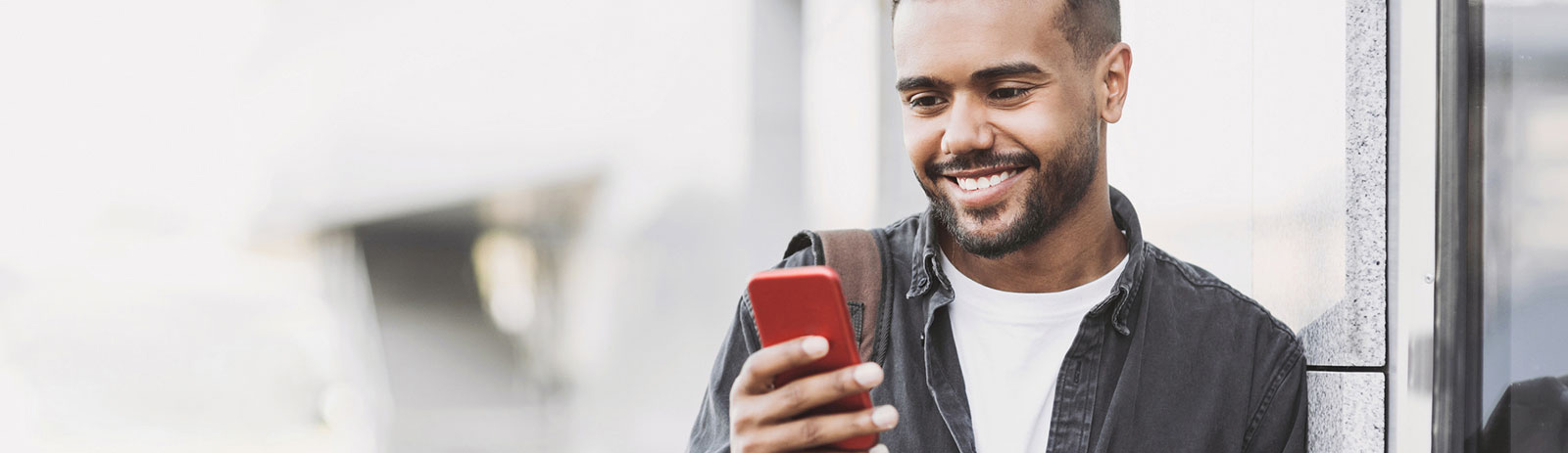 Young man using phone in public