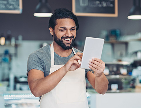 Business owner using tablet in store