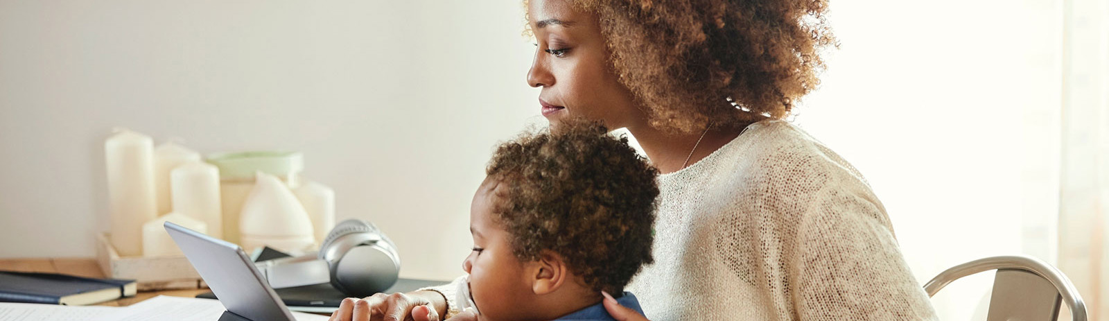 Mother and child using tablet in kitchen