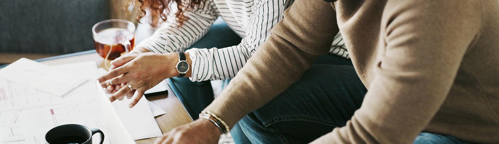 Young couple going over finances in living room