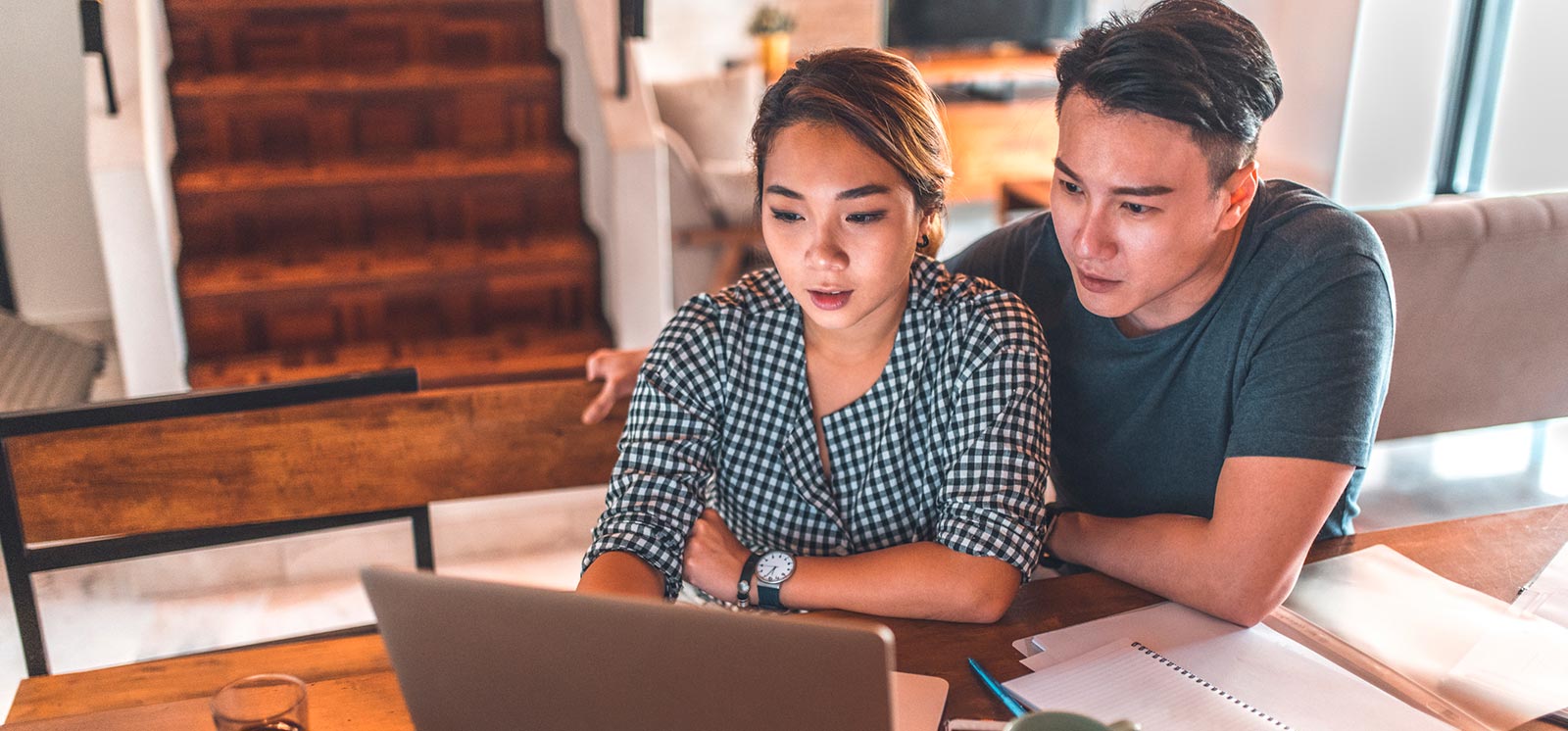 Young couple going over finances in kitchen