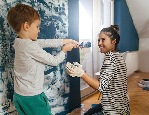 Mother and son painting new house