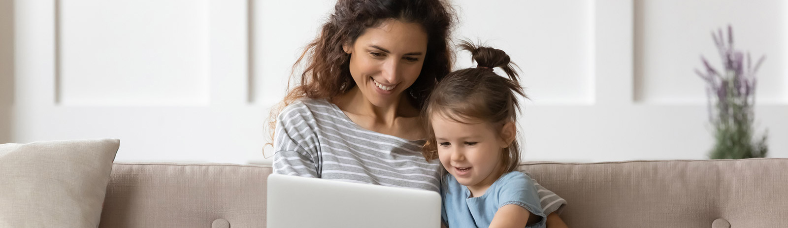 Mother and child using laptop in living room